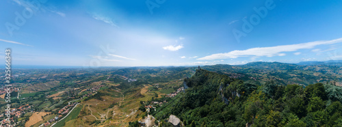 Aerial wide view on Third tower on top of the mountain. Fortifications, in the background mountains and the city. The concept of wide panorama wallpaper Europe. San Marino, Italy