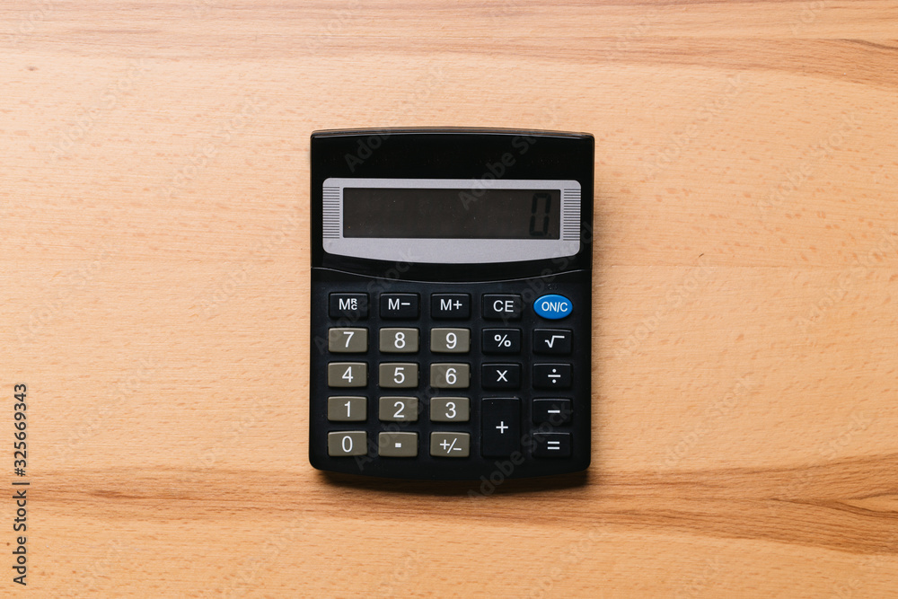 Modern calculator, Business and Finance accounting concept on wooden table Modern calculator, Business and Finance accounting concept on wooden table