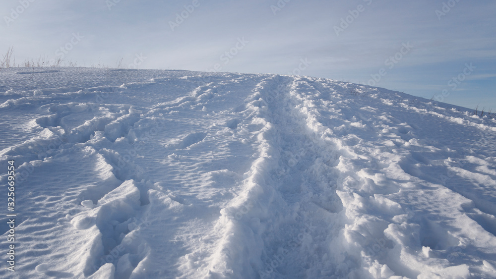 Big snowy hill. Snowy path on the hill. Winter landscape.