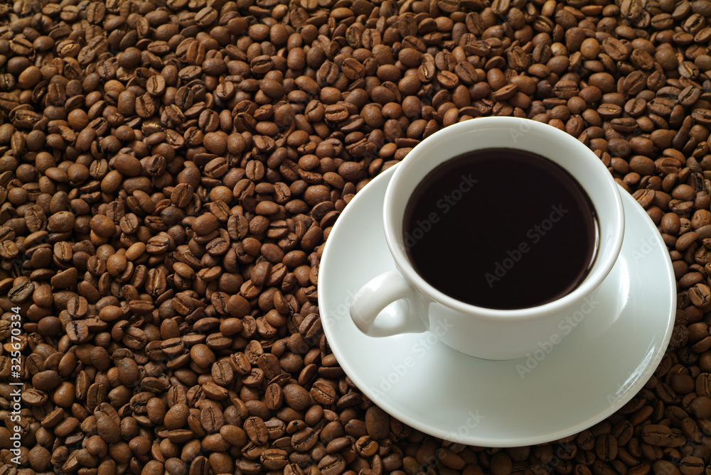 Cup of coffee on coffee beans Cup of coffee on coffee beans
