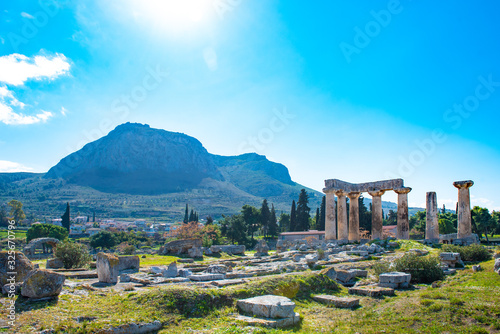 Temple of Apollo with Acrocorinth in the background. Ancient Corinth, Greece. photo