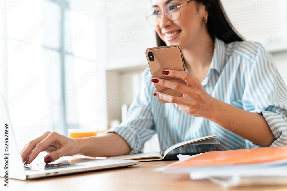 Happy brunette young woman using laptop computer Happy brunette young woman using laptop computer