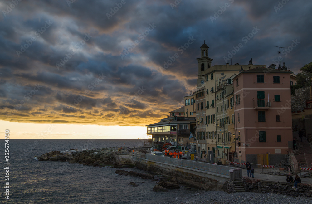 GENOA, ITALY, FEBRUARY 7, 2020 - View of Genova Boccadasse under a cloudy sky at sunset, Italy.