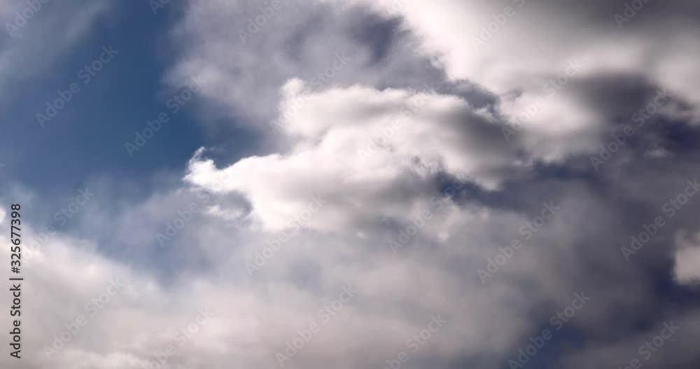 C4K 24p Time-lapse White Clouds Moving Fast On Dark Blue Sky. Strong Wind Weather Change. Fast Motion on Sky C4K 24p Time-lapse White Clouds Moving Fast On Dark Blue Sky. Strong Wind Weather Change. Fast Motion on Sky