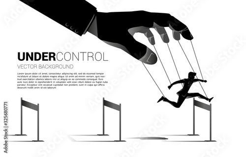 Puppet Master controlling Silhouette of businessman run and jumping across hurdles obstacle. Concept of manipulation and micromanagement