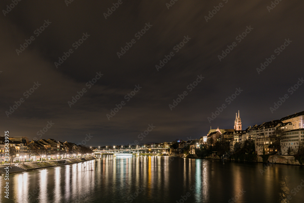 view of the rhine and basel cathedral at night