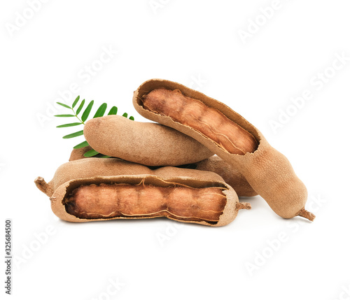 Sweet tamarind, peeled with leaves isolated on white background