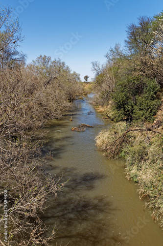A small river flowing through a Game Lodge during the dry season at a location in the Madikwe Game Reserve in South Africa.