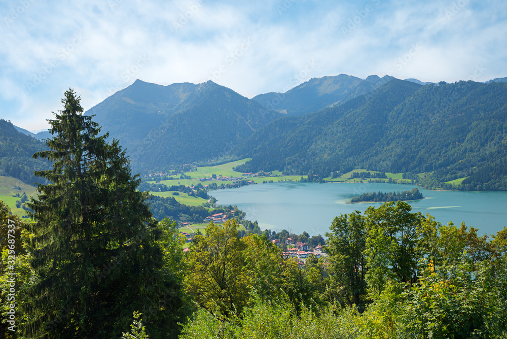 idyllic mountain landscape upper bavaria, view to Brecherspitze and lake Schliersee, green trees in may