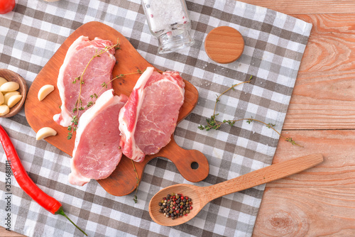 Raw pork chops with thyme, ...