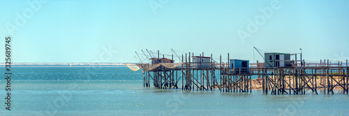 Typical old wooden fishing huts on stilts in the atlantic ocean near La Rochelle, France