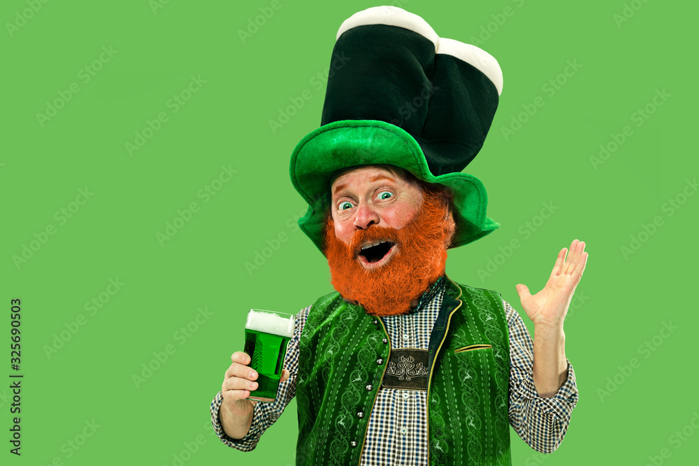 Funny mature man with blank poster on white background. St. Patrick's Day  celebration Stock Photo