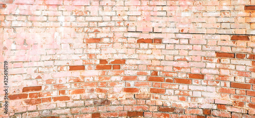 Стена  A wall of old, multicolored bricks with a ruined one . Background texture for advertising or graffiti design with free space for text. Unusual multi-colored, cheerful wall of bricks.