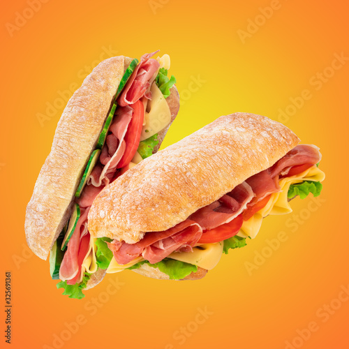 Ciabatta sandwich with lettuce, tomatoes prosciutto and cheese photo