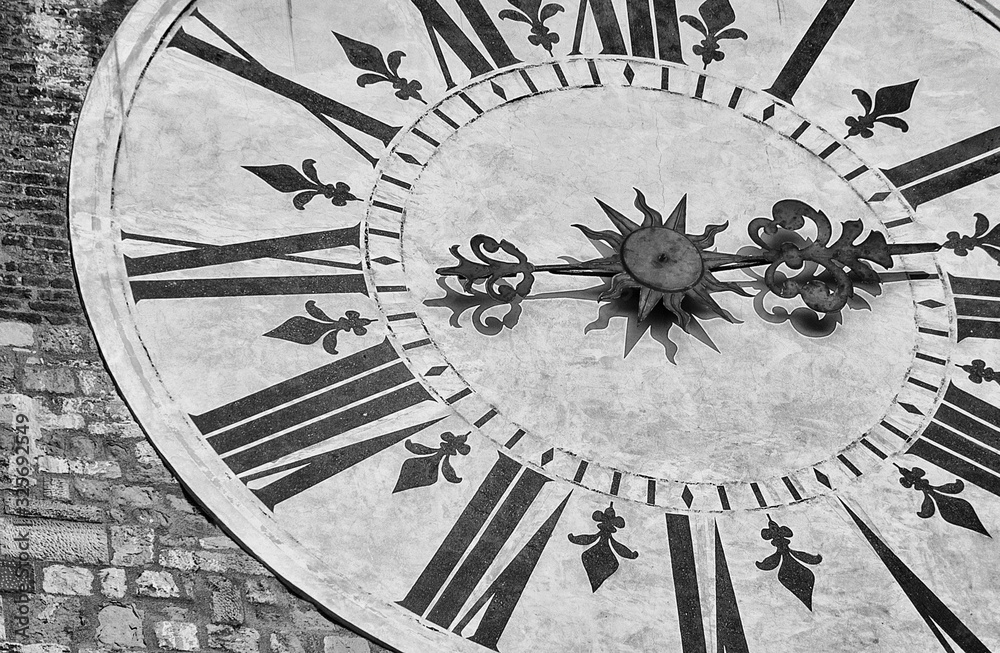 Ancient times and hours Black and White background. Old clock with roman numbers from Lucca clocktower (18th century)