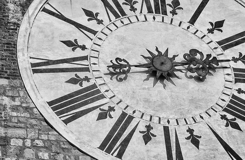 Ancient times and hours Black and White background. Old clock with roman numbers from Lucca clocktower (18th century)