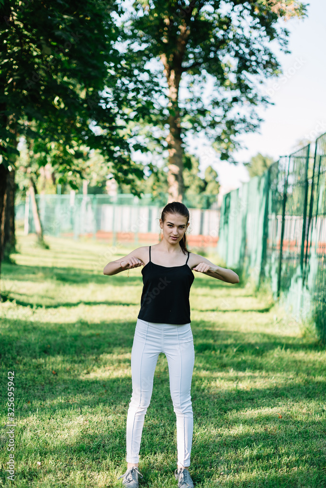 Young beautiful girl doing yoga outdoors in the park