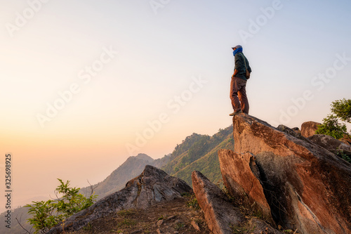 Tourists stand on a rock at Doi Pha Tang Noen 104 on February 16,2020 in Chiang Rai,Thailand.