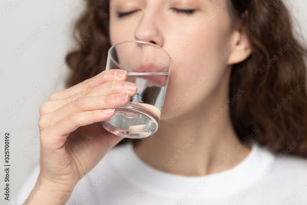 Young healthy woman drinking glass of fresh pure filtered water. Young healthy woman drinking glass of fresh pure filtered water.