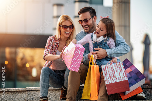 Happy family with shopping bags photo