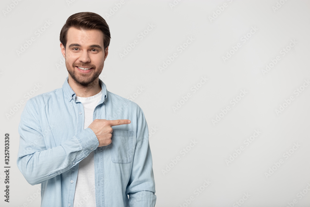 Smiling client pointing finger aside at empty free copy space. Smiling client pointing finger aside at empty free copy space.