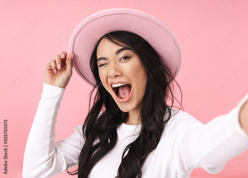 Cheerful pretty young asian woman taking a selfie Cheerful pretty young asian woman taking a selfie