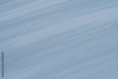 Background of blue stripes at an angle on white snow.