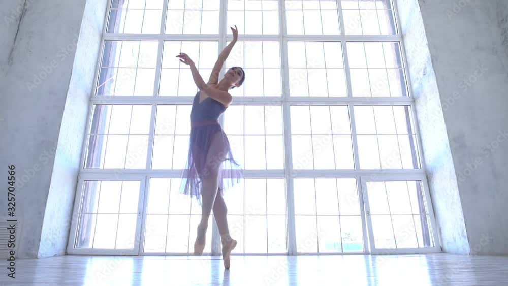 ballet dancer is spinning and jumping high in a tutu and pointe shoes. young ballerina is dancing. slow motion ballet dancer is spinning and jumping high in a tutu and pointe shoes. young ballerina is dancing. slow motion