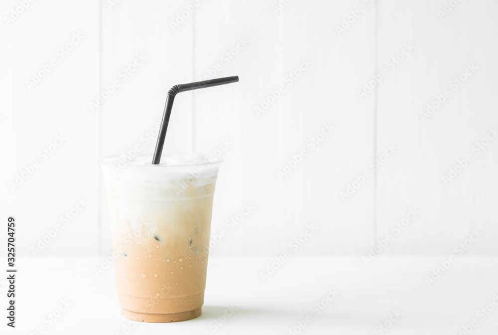 Iced coffee cup on glass cup on white table background. Copy space for your text Iced coffee cup on glass cup on white table background. Copy space for your text