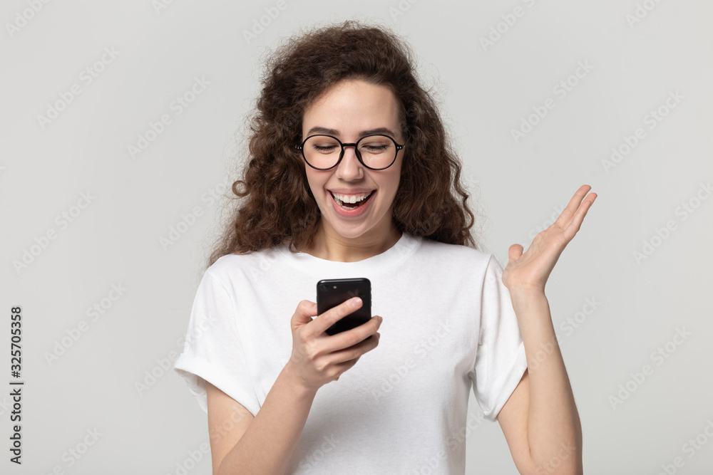 Excited attractive millennial girl received promo offer sms.