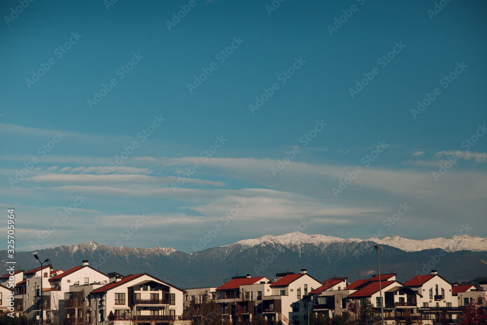 Cottages on a background of mountains and blue sky