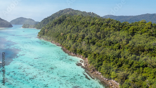 Overhead aerial view of beautiful ocean with coral reef from drone