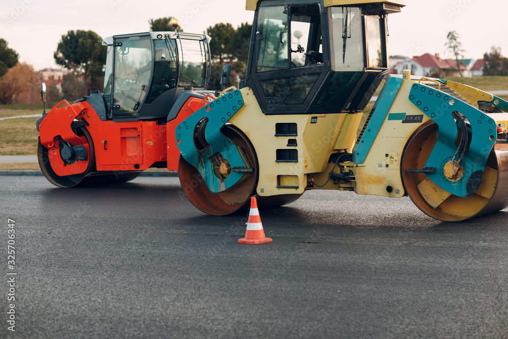 Asphalt paving. Paver machine and road roller. New road construction. Asphalt paving. Paver machine and road roller. New road construction.