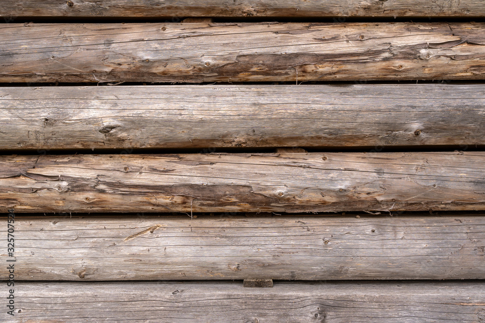 Naklejka premium Wooden cut logs stacked in pile