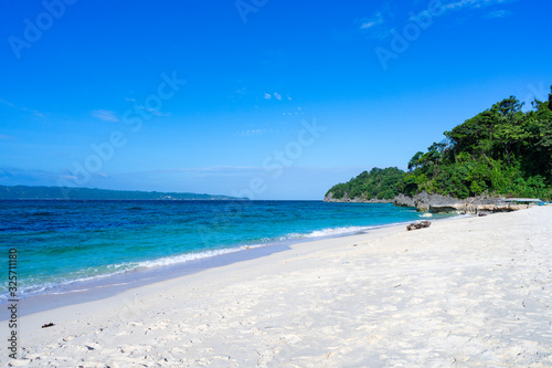 Beautiful Boracay Puka beach during day with clear blue sky and teal blue sea water photo