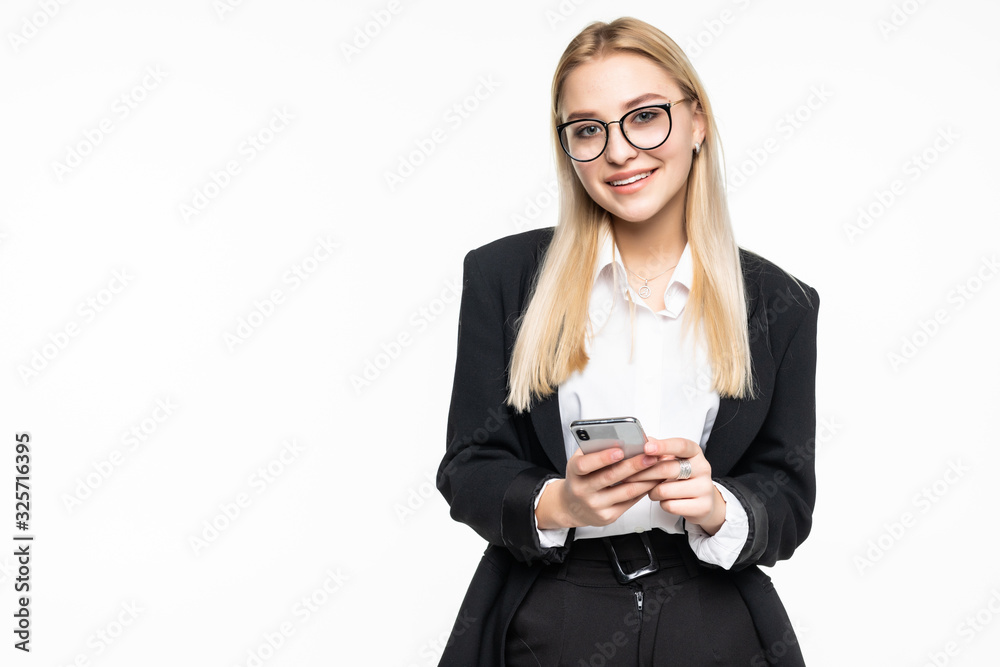 Smiling businesswoman using smartphone over gray background. Smiling businesswoman using smartphone over gray background.