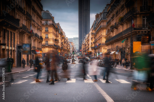 People are walking and crossing the street in Paris city centre