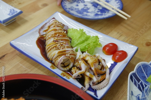 grilled squid with soy sauce on plate Japanese restaurant