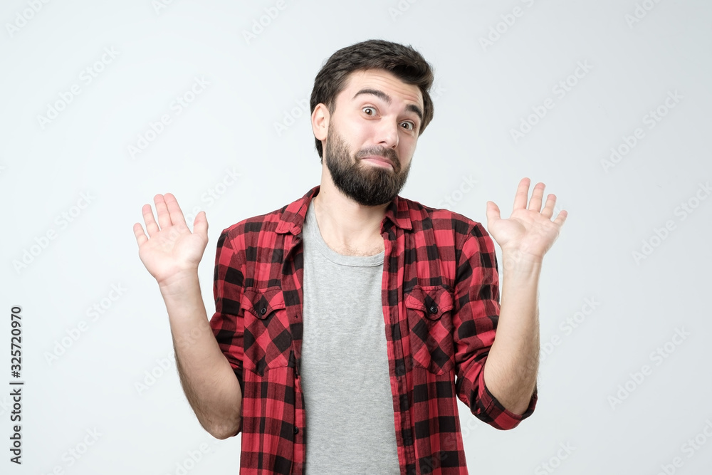 Young man expressing carefree responsibility for childish mistake Young man expressing carefree responsibility for childish mistake