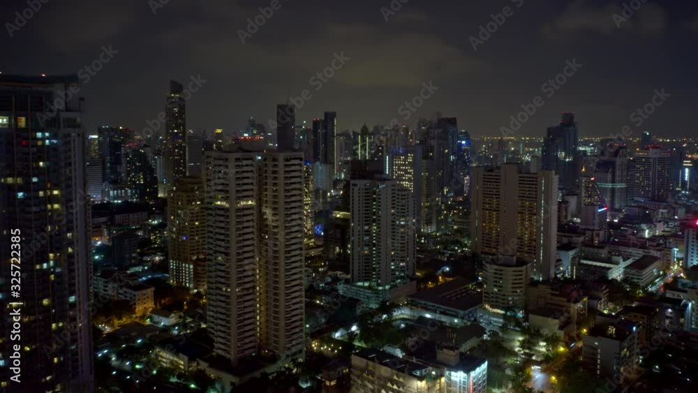 Bangkok Thailand Aerial v184 Hyperlapse flying backwards out of downtown skyscrapers in Watthana district at night - January 2020 Bangkok Thailand Aerial v184 Hyperlapse flying backwards out of downtown skyscrapers in Watthana district at night - January 2020