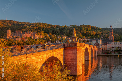Stunning reddish sunset over the old town, castle and main city bridge in Heidelberg, Germany, panoramic view