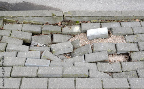 Failure of paving tiles on the footpath photo