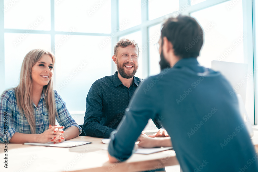 group of business people conducting an interview sitting at the table