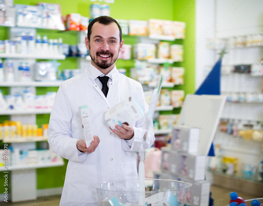 Smiling male pharmacist suggesting useful drug