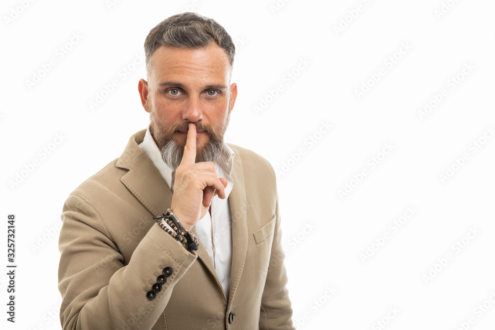 Man wearing smart casual clothes making silence gesture Man wearing smart casual clothes making silence gesture