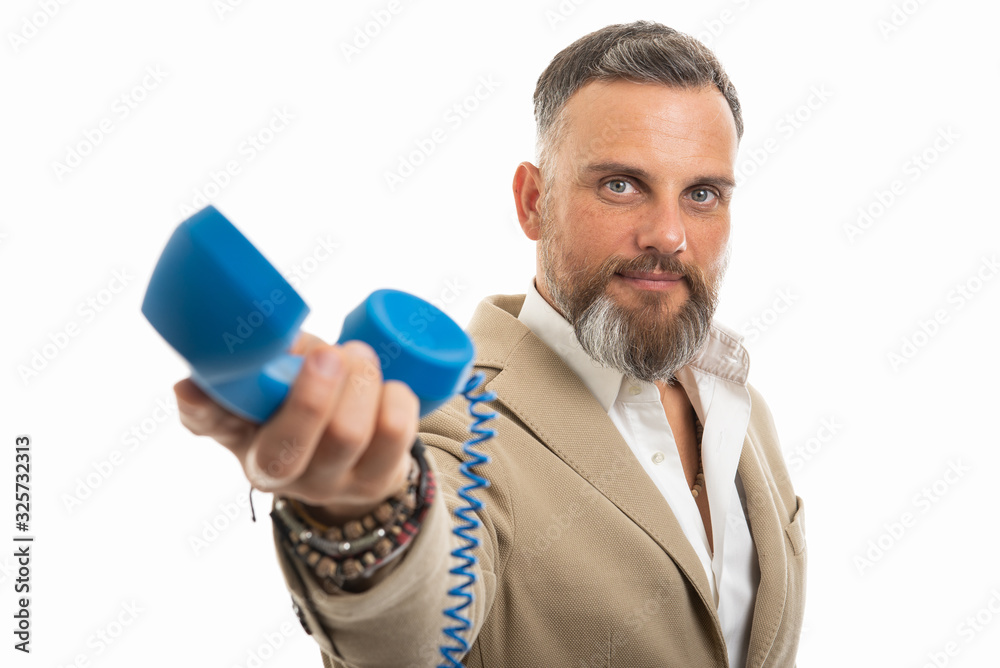 Man wearing smart casual clothes handing blue telephone receiver Man wearing smart casual clothes handing blue telephone receiver