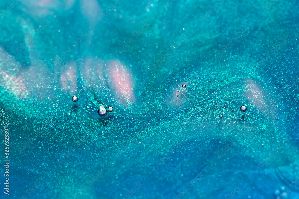 macro shot of blue and pink alcohol ink dissolving in water, abstract background