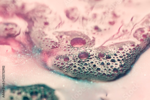 macro shot of pink soap foam texture with bubbles