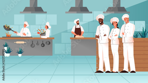 Professional chefs standing together in the restaurant kitchen.