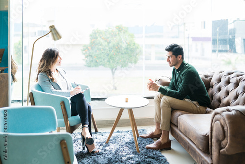 Counselor Talking To Young Man At Office